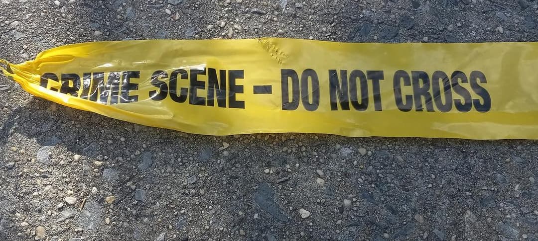 Police crime-scene tape stretched across a New York sidewalk