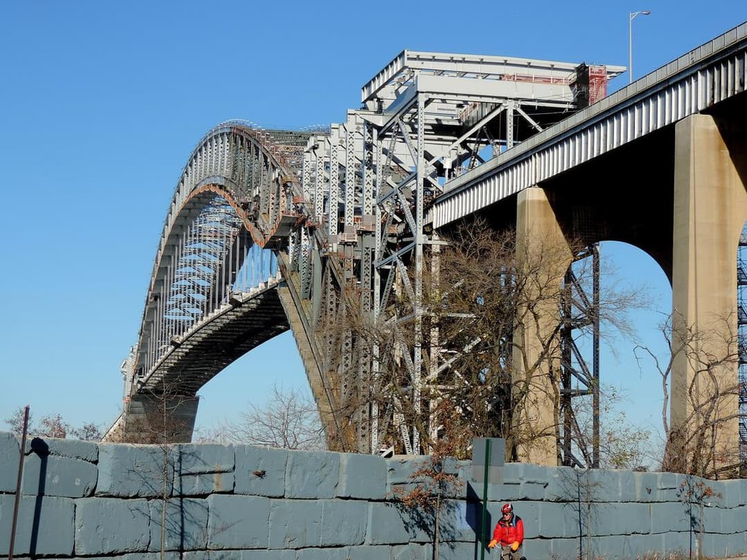 Scaffolding wrapping a bridge approach under renovation